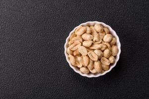 Delicious nutritious peanut in ceramic bowl photo
