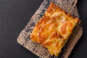 Lasagna or pasta layered with meat, cheese, salt, spices and herbs photo