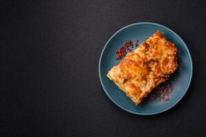 Lasagna or pasta layered with meat, cheese, salt, spices and herbs photo