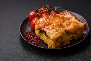 Lasagna or pasta layered with meat, cheese, salt, spices and herbs photo
