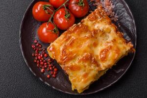 Lasagna or pasta layered with meat, cheese, salt, spices and herbs photo