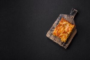 Lasagna or pasta layered with meat, cheese, salt, spices and herbs photo