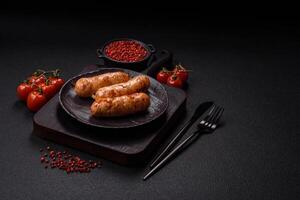 Grilled sausages with spices and herbs photo