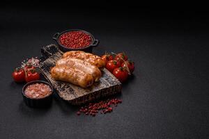 Grilled sausages with spices and herbs photo