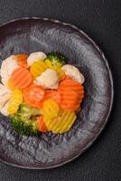 Delicious fresh vegetables steamed carrots, broccoli, cauliflower photo