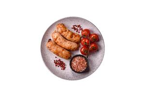 Grilled sausages with spices and herbs photo