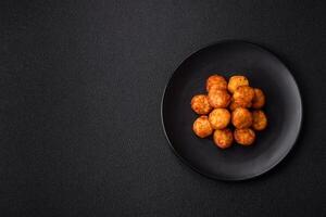 Delicious fried potato balls or croquettes with salt, spices and herbs photo