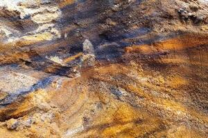 slopes are a quarry with a rock containing gold. Searching for gold. photo