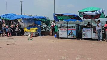 Goa , India 28th April 2024 A collection of colorful vendor stalls set up near the waterfront. as seen form the Dona Paula viewpoint video