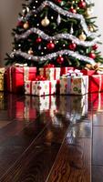 Close-up dark wooden floor with brightly decorated Christmas tree and colorful gifts in background photo