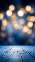 In foreground blue wooden surface with blurred background of warm golden lights with bokeh effect. photo