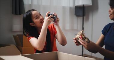 Selective focus, Two siblings happily sit on the floor talking as they unpack belongings from boxes to decorate a room in new home. Moving to a new home concept photo