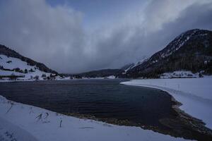 Winter scenery with view over a lake in the Swiss Alps, Grisons, Switzerland photo