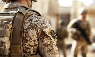 A soldier is standing in front of a group of men photo