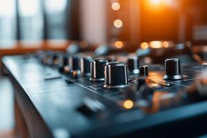 Close-up of a mixing console with knobs and controls for audio production. photo