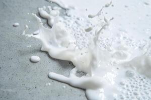 A splash of white liquid on a textured surface, creating dynamic patterns. photo