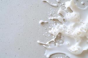 A splash of milk on a textured surface, showcasing fluid dynamics. photo