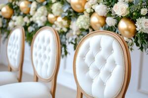 Luxurious party setup featuring golden balloons and elegant floral arrangements for a sophisticated celebration photo
