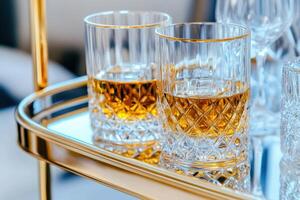 Elegant golden bar cart adorned with crystal decanters and fine spirits set in a luxurious living space photo