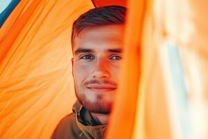 Soldier enjoys a call from his tent while deployed, surrounded by warm light in a minimalistic setting photo
