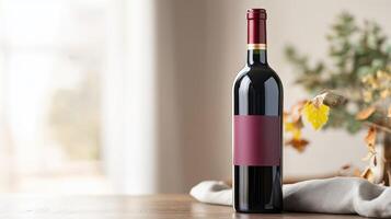 Luxurious burgundy wine bottle on wooden table with gray linen in elegant setting during daytime photo