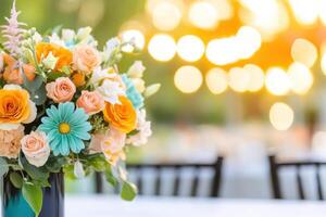 Elegant outdoor wedding setup featuring teal and terracotta floral arrangements with natural wooden tables in evening light photo