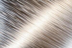 Stainless steel surface with subtle brushed patterns reflecting soft light, ideal for modern and industrial aesthetics photo