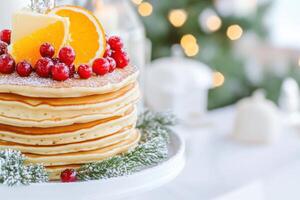 Delicious brunch setup featuring stacked pancakes topped with orange slices, butter, and berry compote in a cozy setting photo
