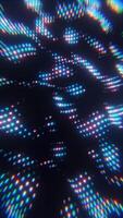 A colorful light pattern is shown in the dark video