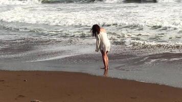Latina Woman With White Sweater Over Bikini Walking On Beach Near Waves Rodeo Beach Marin California video