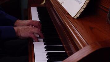 Older Man's Hands Playing On Upright Piano From The Side video