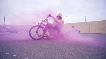 An exciting Dynamic Trike Ride featuring a beautiful pink smoke effect in a vibrant urban setting video