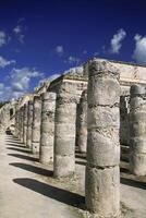 The columns are made of stone and are in a row photo
