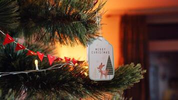 A christmas tree decorated with a christmas ornament and a tag photo