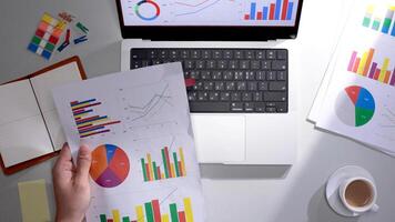 A person is holding a piece of paper with graphs on it photo