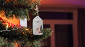 A christmas tag hangs from a christmas tree photo