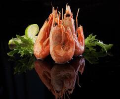Shrimp on a black background with a lime wedge photo