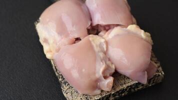 Fresh raw chicken thigh fillets with salt, spices and herbs on a dark concrete background video