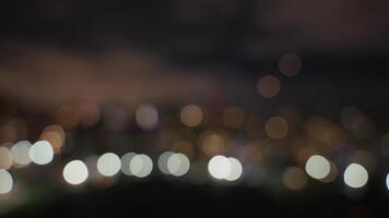 A blurred background with night lights and a bokeh effect creates a serene, artistic atmosphere video