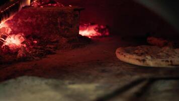 Chef Moving The Pizza Inside The Traditional Oven video