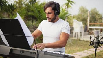 Boy Pianist Plays The Keyboard In An Outdoor Garden For A Private Party video