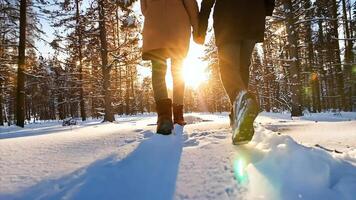 Close Up Shot of a couple's legs bottom view walking on a snowy day video