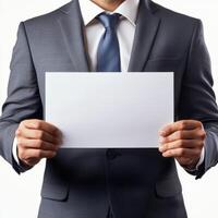 Businessman holding a blank sheet of paper in a professional setting during daylight hours photo