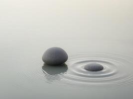 Two rocks in the water with a wave in the middle photo