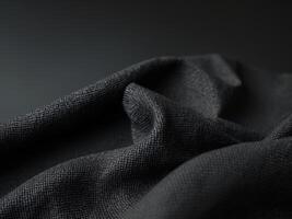Textured black fabric background showcasing coarse woven structure ideal for design and textile applications. photo