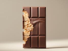 A piece of chocolate bar with a piece of cracker photo