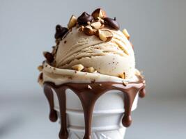 Delicious hazelnut ice cream dripping with chocolate and toppings. photo