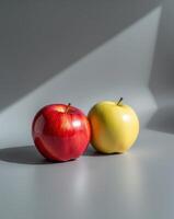 Vibrant Red and Yellow Apples with Glossy Texture on Gray Background. photo
