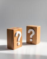 Two wooden blocks with a question mark on each photo