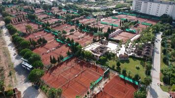 Clay Tennis Courts with Players and Urban Backdrop video